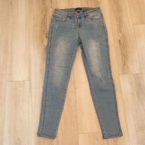 Pale jeans with small decorative holes
